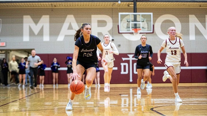 Johnston's Kelli Kalb (22) drives down the court against Dowling Catholic on Friday, Jan. 24, 2025, at Dowling Catholic High School