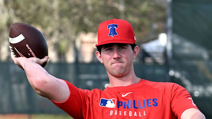 Philadelphia Phillies pitcher Andrew Painter (76) throws a football during a spring training workout at Carpenter Complex Mandatory Credit on Feb. 12. Philadelphia Phillies pitcher Andrew Painter (76) throws a football during a spring training workout at Carpenter Complex Mandatory Credit on Feb. 12.