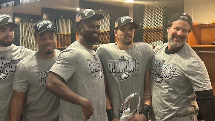 Eagles linebackers - left to right: Ben Van Sumeren, Jeremiah Trotter, Jr., Oren Burks, Zack Baun, and position coach Bobby King - pose with the NFC trophy after beating the Washington Commanders in the conference title game. Eagles linebackers - left to right: Ben Van Sumeren, Jeremiah Trotter, Jr., Oren Burks, Zack Baun, and position coach Bobby King - pose with the NFC trophy after beating the Washington Commanders in the conference title game.