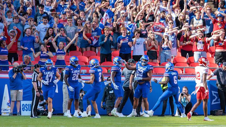 Oct 19, 2024; Kansas City, Missouri, USA; Kansas Jayhawks celebrate after scoring a touchdown against the Houston Cougars during the second quarter at GEHA Field at Arrowhead Stadium. Mandatory Credit: William Purnell-Imagn Images