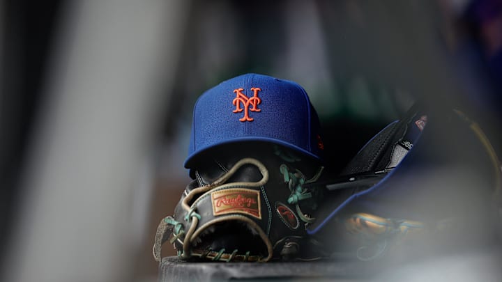 Aug 8, 2024; Denver, Colorado, USA; A New York Mets hat and glove in the dugout in the second inning against the Colorado Rockies at Coors Field. Mandatory Credit: Isaiah J. Downing-Imagn Images