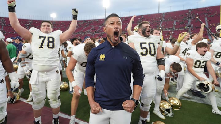 Nov 30, 2024; Los Angeles, California, USA; Notre Dame Fighting Irish head coach Marcus Freeman celebrates with players at the end of the game against the Southern California Trojans at United Airlines Field at Los Angeles Memorial Coliseum. Mandatory Credit: Kirby Lee-Imagn Images