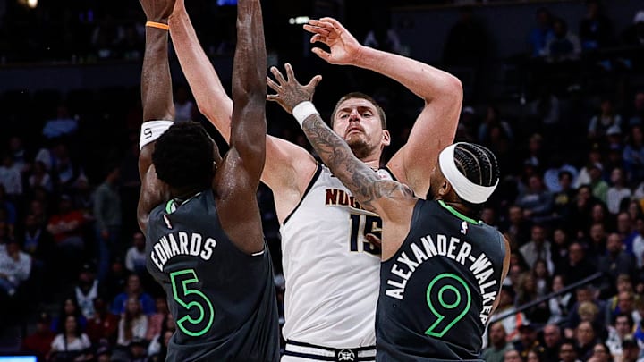 Apr 1, 2025; Denver, Colorado, USA; Denver Nuggets center Nikola Jokic (15) passes the ball under pressure from Minnesota Timberwolves guard Anthony Edwards (5) and guard Nickeil Alexander-Walker (9) in the fourth quarter at Ball Arena. Mandatory Credit: Isaiah J. Downing-Imagn Images Apr 1, 2025; Denver, Colorado, USA; Denver Nuggets center Nikola Jokic (15) passes the ball under pressure from Minnesota Timberwolves guard Anthony Edwards (5) and guard Nickeil Alexander-Walker (9) in the fourth quarter at Ball Arena. Mandatory Credit: Isaiah J. Downing-Imagn Images