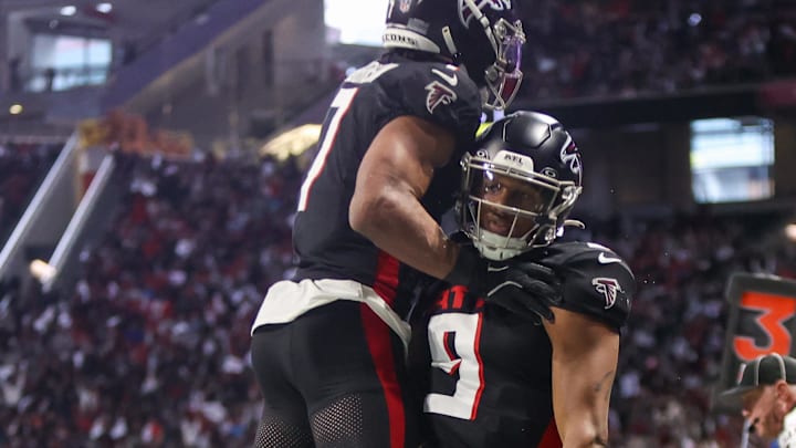 Atlanta Falcons quarterback Michael Penix Jr. (9) celebrates with running back Bijan Robinson (7) after a touchdown run.