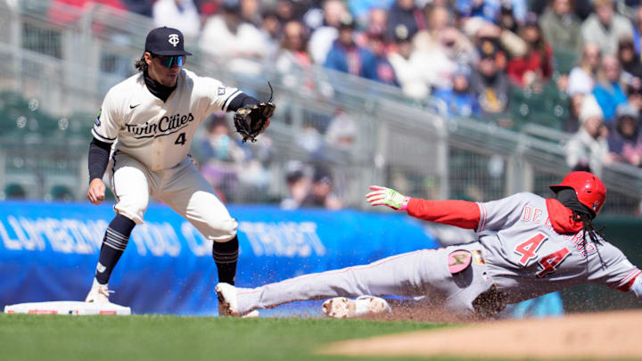 Apr 19, 2026; Minneapolis, Minnesota, USA; Cincinnati Reds shortstop Elly de la Cruz (44) slides into third base, beating the throw to Minnesota Twins third baseman Tristan Gray (4) in the fourth inning at Target Field. Mandatory Credit: Matt Blewett-Imagn Images
