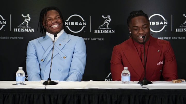 Colorado Buffaloes wide receiver/cornerback Travis Hunter, left, smiles alongside Boise State Broncos running back Ashton Jeanty during a press conference before the 2024 Heisman Trophy ceremony.