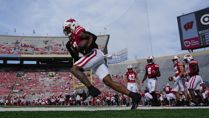 Sep 20, 2025; Madison, Wisconsin, USA; Wisconsin Badgers running back Dilin Jones (7) carries the football during warmups prior to the game against the Maryland Terrapins at Camp Randall Stadium. Sep 20, 2025; Madison, Wisconsin, USA; Wisconsin Badgers running back Dilin Jones (7) carries the football during warmups prior to the game against the Maryland Terrapins at Camp Randall Stadium.