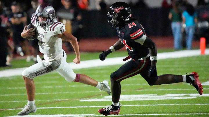 Riverview quarterback Logan Carillo (#4) scramble toward the sideline as he is chased by Palmetto lilnebacker Josiah Washington (#24). The Palmetto High School Tigers hosted the Riverview High School Rams on Friday evening, Sept. 4, 2026. Riverview quarterback Logan Carillo (#4) scramble toward the sideline as he is chased by Palmetto lilnebacker Josiah Washington (#24). The Palmetto High School Tigers hosted the Riverview High School Rams on Friday evening, Sept. 4, 2026.