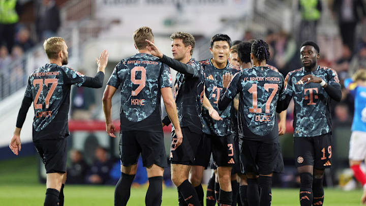 Bayern Munich players celebrating a goal against Holstein Kiel on matchday three of the Bundesliga.