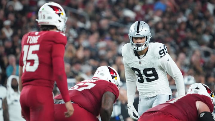 Las Vegas Raiders defensive end Andre Carter II (99) looks down Arizona Cardinals quarterback Clayton Tune (15) during the second half at State Farm Stadium.