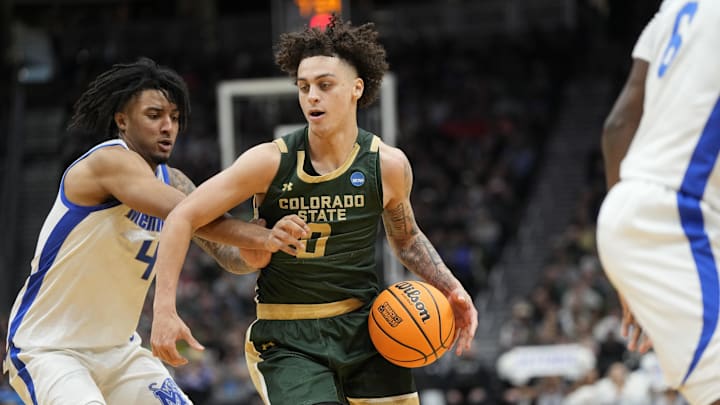 Mar 21, 2025; Seattle, WA, USA; Colorado State Rams guard Kyan Evans (0) drives the ball past Memphis Tigers guard PJ Haggerty (4) during the second half at Climate Pledge Arena. Mar 21, 2025; Seattle, WA, USA; Colorado State Rams guard Kyan Evans (0) drives the ball past Memphis Tigers guard PJ Haggerty (4) during the second half at Climate Pledge Arena.