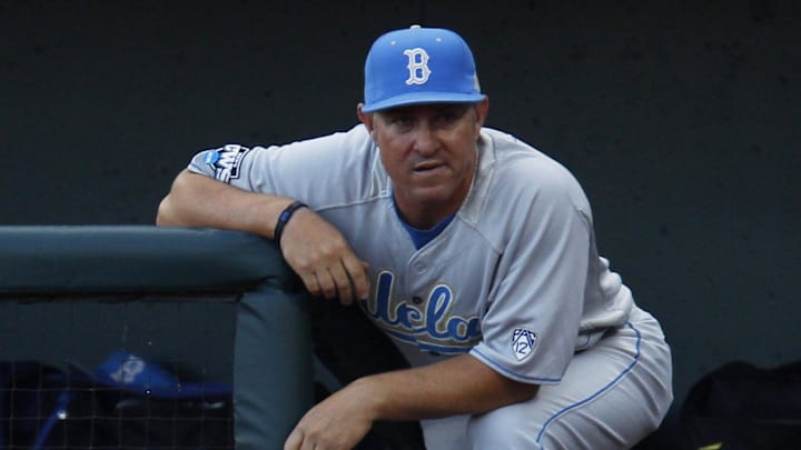 June 17, 2012; Omaha, NE, USA;  UCLA Bruins head coach John Savage watches from the dugout prior to the game against the Arizona Wildcats in six of the 2012 College World Series at TD Ameritrade Park. Mandatory Credit: Bruce Thorson-Imagn Images
