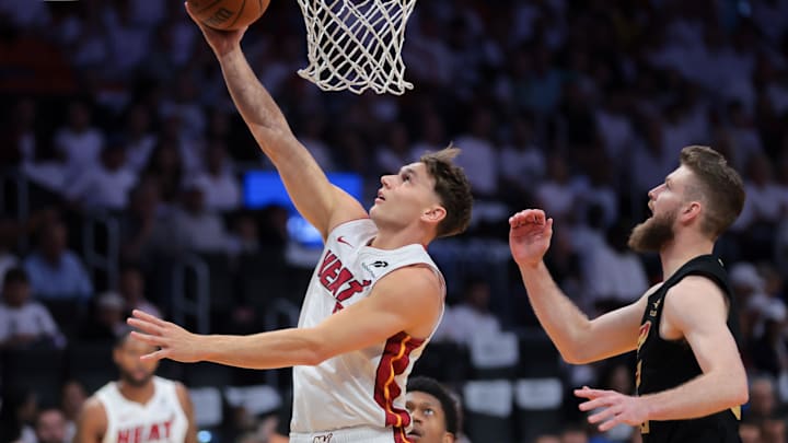Apr 28, 2025; Miami, Florida, USA; Miami Heat guard Pelle Larsson (9) scores past Cleveland Cavaliers forward Dean Wade (32) in the first quarter during game four for the first round of the 2025 NBA Playoffs at Kaseya Center. Mandatory Credit: Sam Navarro-Imagn Images Apr 28, 2025; Miami, Florida, USA; Miami Heat guard Pelle Larsson (9) scores past Cleveland Cavaliers forward Dean Wade (32) in the first quarter during game four for the first round of the 2025 NBA Playoffs at Kaseya Center. Mandatory Credit: Sam Navarro-Imagn Images
