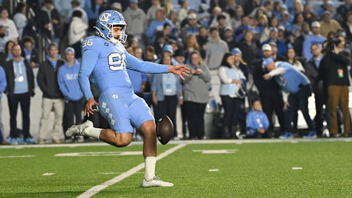 Nov 16, 2024; Chapel Hill, North Carolina, USA; North Carolina Tar Heels punter Tom Maginness (96) punts in the first quarter at Kenan Memorial Stadium. Mandatory Credit: Bob Donnan-Imagn Images