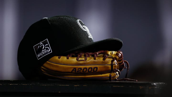 Sep 5, 2018; Denver, CO, USA; A detail view of a Colorado Rockies hat on top of a glove in the seventh inning against the San Francisco Giants at Coors Field. Sep 5, 2018; Denver, CO, USA; A detail view of a Colorado Rockies hat on top of a glove in the seventh inning against the San Francisco Giants at Coors Field.