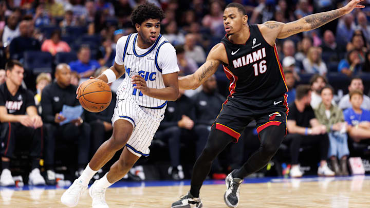 Oct 12, 2025; Orlando, Florida, USA; Orlando Magic guard Jase Richardson (11) drives to the basket while Miami Heat forward Keshad Johnson (16) defends during the second half at Kia Center. Mandatory Credit: Matt Pendleton-Imagn Images