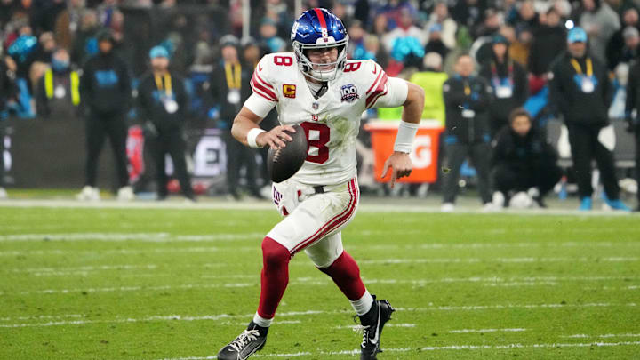 Nov 10, 2024; Munich, Germany; New York Giants quarterback Daniel Jones (8) carries the ball against the New York Giants in the second half during the 2024 NFL Munich Game at Allianz Arena. Mandatory Credit: Kirby Lee-Imagn Images