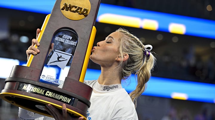LSU Tigers gymnast Olivia Dunne kisses the trophy after the LSU Tigers gymnastics team wins the national championship in the 2024 Womens National Gymnastics Championship.