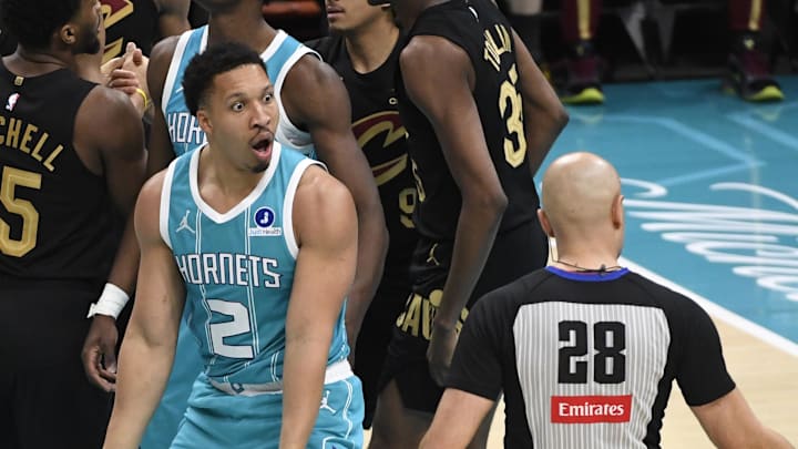 Jan 21, 2026; Charlotte, North Carolina, USA;  Charlotte Hornets forward Grant Williams (2) complains to referee Mousa Dagher (28) after a foul call during the second half against the Cleveland Cavaliers at the Spectrum Center. Mandatory Credit: Sam Sharpe-Imagn Images