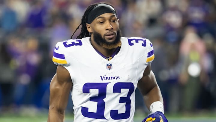 Jan 13, 2025; Glendale, AZ, USA; Minnesota Vikings running back Aaron Jones Sr. (33) against the Los Angeles Rams during an NFC wild card game at State Farm Stadium. Mandatory Credit: Mark J. Rebilas-Imagn Images