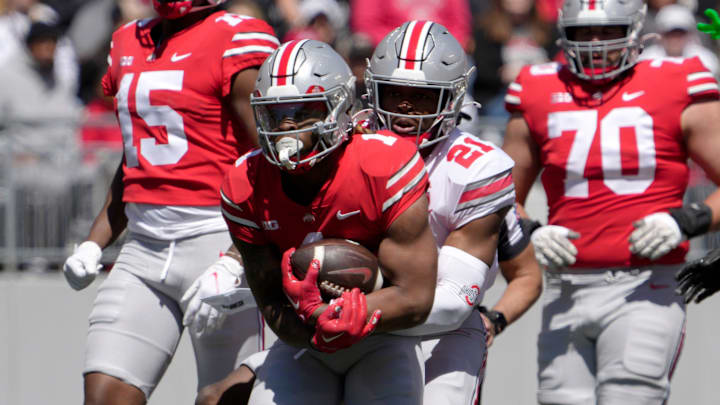 April 13, 2024; Columbus, Ohio, USA; 
Ohio State Buckeyes running back Quinshon Judkins (1) of the scarlet team is tagged by safety Jayden Bonsu (21) of the grey team during the first half of the LifeSports spring football game at Ohio Stadium on Saturday.