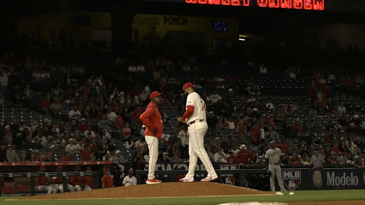 Jun 9, 2025; Anaheim, California, USA;   Los Angeles Angels manager Ron Washington (37) brings in relief pitcher Kenley Jansen (74) to close out the ninth inning against the Athletics at Angel Stadium. Mandatory Credit: Jayne Kamin-Oncea-Imagn Images