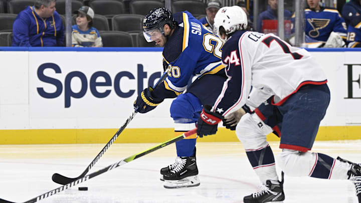 Sep 26, 2023; St. Louis, Missouri, USA; St. Louis Blues left wing Brandon Saad (20) controls the puck from Columbus Blue Jackets defenseman Corson Ceulemans (74) during the second period at Enterprise Center. Mandatory Credit: Jeff Le-Imagn Images