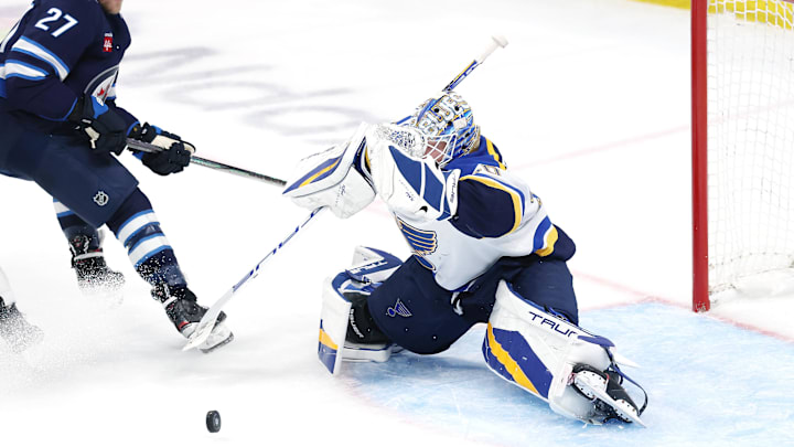 May 4, 2025; Winnipeg, Manitoba, CAN; St. Louis Blues goaltender Jordan Binnington (50) blocks a shot by Winnipeg Jets left wing Nikolaj Ehlers (27) in first overtime in game seven of the first round of the 2025 Stanley Cup Playoffs at Canada Life Centre. Mandatory Credit: James Carey Lauder-Imagn Images
