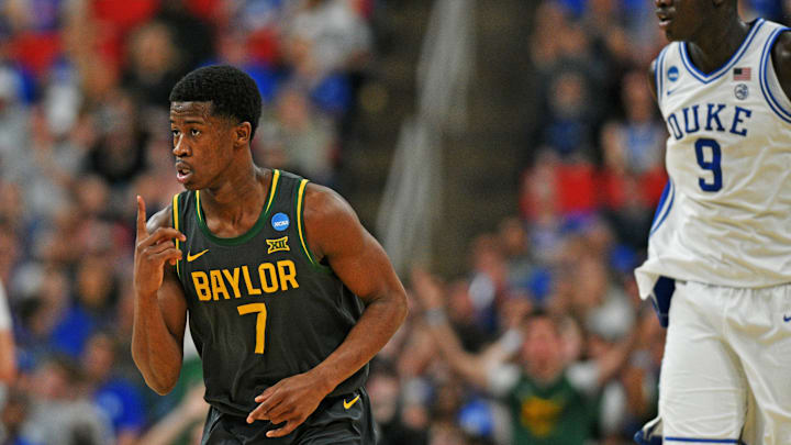 Mar 23, 2025; Raleigh, NC, USA; Baylor Bears guard VJ Edgecombe (7) reacts after a play as Duke Blue Devils center Khaman Maluach (9) looks on during the second half in the second round of the NCAA Tournament at Lenovo Center. Mandatory Credit: Zachary Taft-Imagn Images