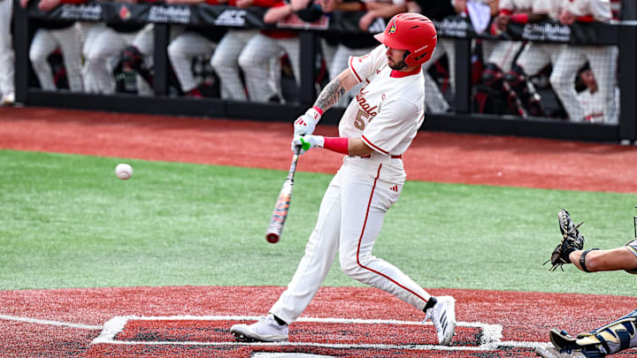 Louisville baseball outfielder Lucas Moore puts a ball into play. Louisville baseball outfielder Lucas Moore puts a ball into play.