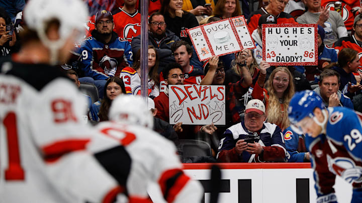 Feb 26, 2025; Denver, Colorado, USA; New Jersey Devils fans hold up signs in the second period against the Colorado Avalanche at Ball Arena. Mandatory Credit: Isaiah J. Downing-Imagn Images