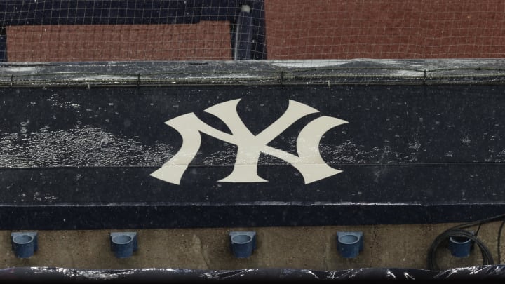 Aug 17, 2020; Bronx, New York, USA; A general view of rain falling on the  New York Yankees logo on the first base dugout roof during a rain delay in the game between the New York Yankees and the Boston Red Sox. Mandatory Credit: Vincent Carchietta-USA TODAY Sports