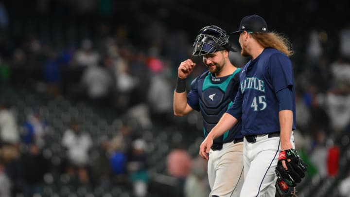 Seattle Mariners catcher Cal Raleigh (29) and relief pitcher Ryne Stanek (45) walk off the field after defeating the Chicago White Sox at T-Mobile Park on June 11.