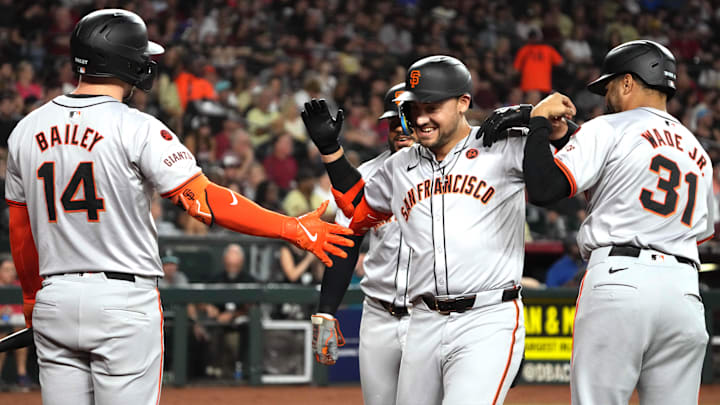 Sep 24, 2024; Phoenix, Arizona, USA; San Francisco Giants outfielder Michael Conforto celebrates with catcher Patrick Bailey and first base LaMonte Wade Jr. 