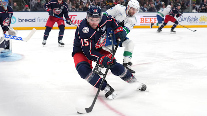 Blue Jackets defenseman Dante Fabbro tries to make a play with the puck against the Vancouver Canucks. 