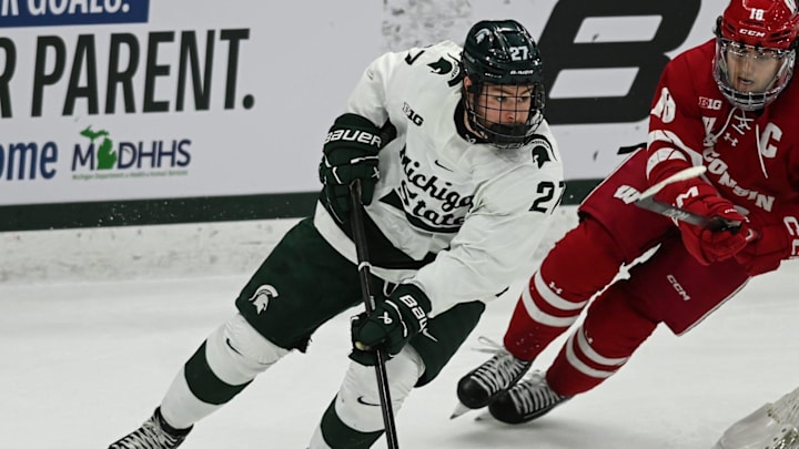 MSU's Nicklas Andrews moves the puck against Wisconsin's Owen Lindmark, Thursday, Jan. 2, 2024, at Munn Ice Arena. MSU won 4-3. MSU's Nicklas Andrews moves the puck against Wisconsin's Owen Lindmark, Thursday, Jan. 2, 2024, at Munn Ice Arena. MSU won 4-3.