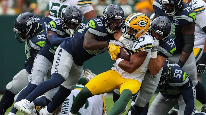 Green Bay Packers running back Chris Brooks (30) is tackled by Seattle Seahawks linebackers Jamie Sheriff (50) and Patrick O'Connell (52) during their final preseason game on Saturday, August 23, 2025, at Lambeau Field in Green Bay, Wis. 
Tork Mason/USA TODAY NETWORK-Wisconsin