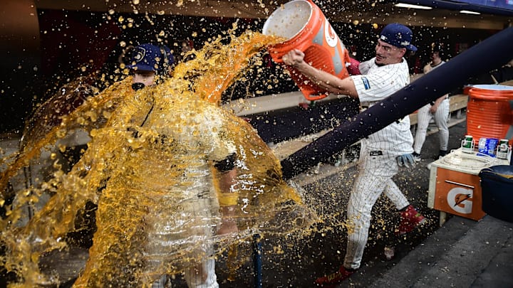 Oct 2, 2024; Milwaukee, Wisconsin, USA; Milwaukee Brewers outfielder Garrett Mitchell (5) is dunked with sports drink by teammate Willy Adames (27) after their game two win over the New York Mets in the wildcard round for the 2024 MLB Playoffs at American Family Field. Mandatory Credit: Benny Sieu-Imagn Images