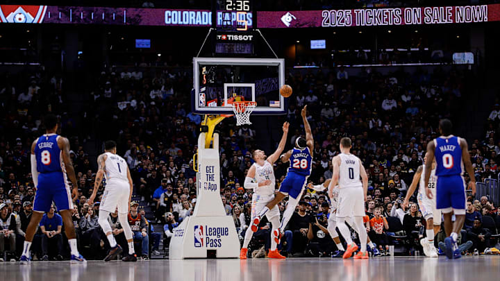 Jan 21, 2025; Denver, Colorado, USA; Philadelphia 76ers forward Guerschon Yabusele (28) drives to the basket against Denver Nuggets center Nikola Jokic (15) as forward Paul George (8) and forward Michael Porter Jr. (1) and guard Christian Braun (0) and guard Tyrese Maxey (0) look on in the first quarter at Ball Arena. Mandatory Credit: Isaiah J. Downing-Imagn Images