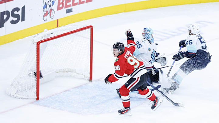 Nov 20, 2025; Chicago, Illinois, USA; Chicago Blackhawks center Connor Bedard (98) reacts to a lack of call against Seattle Kraken defenseman Ryan Lindgren (55) during the third period at United Center. Mandatory Credit: Kamil Krzaczynski-Imagn Images