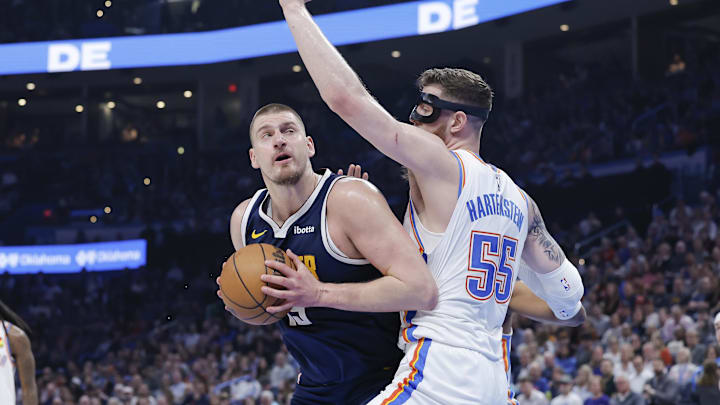 Mar 10, 2025; Oklahoma City, Oklahoma, USA; Denver Nuggets center Nikola Jokic (15) is defended by Oklahoma City Thunder center Isaiah Hartenstein (55) on a drive to the basket during the first quarter at Paycom Center. Mandatory Credit: Alonzo Adams-Imagn Images Mar 10, 2025; Oklahoma City, Oklahoma, USA; Denver Nuggets center Nikola Jokic (15) is defended by Oklahoma City Thunder center Isaiah Hartenstein (55) on a drive to the basket during the first quarter at Paycom Center. Mandatory Credit: Alonzo Adams-Imagn Images