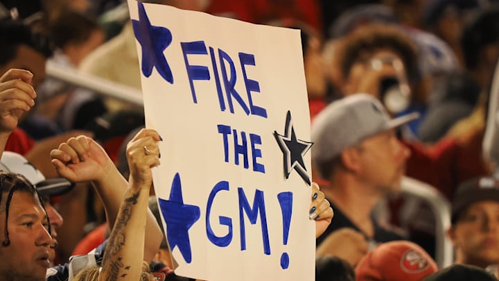 A Dallas Cowboys fan holds a sign reading “fire the GM” during the second quarter against the San Francisco 49ers.