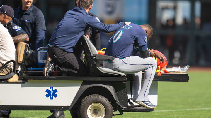 Seattle Mariners right fielder Victor Robles (right) is carted off the field during a game against the San Francisco Giants on April 6 at Oracle Park.