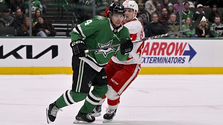 Jan 19, 2025; Dallas, Texas, USA; Dallas Stars defenseman Miro Heiskanen (4) and Detroit Red Wings right wing Jonatan Berggren (48) chase the puck during the third period at the American Airlines Center. Mandatory Credit: Jerome Miron-Imagn Images