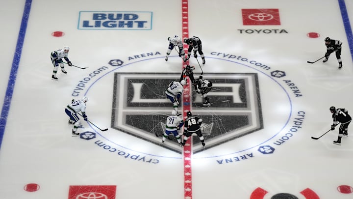 Dec 30, 2021; Los Angeles, California, USA; A general overall view of opening faceoff as referee Garrett Rank (7) drops the puck between Vancouver Canucks center Bo Horvat (53) and LA Kings center Blake Lizotte (46) at Crypto.com Arena. Mandatory Credit: Kirby Lee-Imagn Images