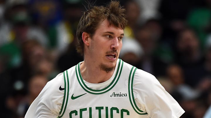 Feb 25, 2026; Denver, Colorado, USA; Boston Celtics guard Baylor Scheierman (55) dribbles the ball around the perimeter during the first half against the Denver Nuggets at Ball Arena. Mandatory Credit: Christopher Hanewinckel-Imagn Images