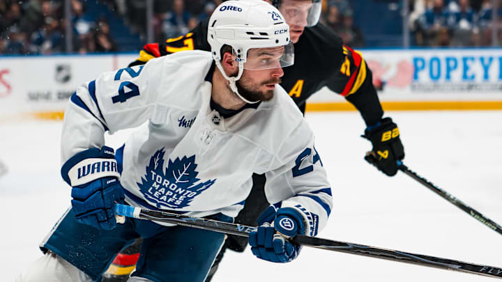 Jan 31, 2026; Vancouver, British Columbia, CAN; Vancouver Canucks defenseman Tyler Myers (57) defends against Toronto Maple Leafs forward Scott Laughton (24) in the third period at Rogers Arena. Mandatory Credit: Bob Frid-Imagn Images