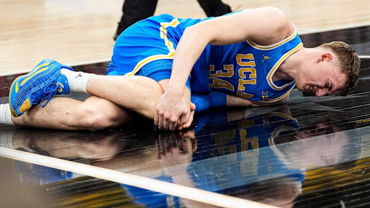 UCLA forward Tyler Bilodeau (34) falls on the court due to injury during the first half of Big Ten tournament quarterfinal against Michigan State at United Center in Chicago on Friday, March 13, 2026.