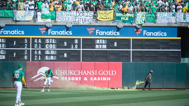 Sep 26, 2024; Oakland, California, USA; Oakland Athletics outfielder Lawrence Butler (4) reacts to smoke bombs being thrown on the field during the ninth inning of the game against the Texas Rangers at Oakland-Alameda County Coliseum. Mandatory Credit: Ed Szczepanski-Imagn Images