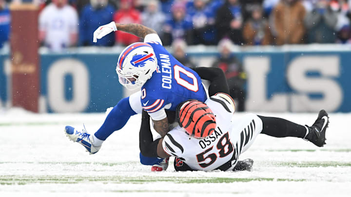 Dec 7, 2025; Orchard Park, New York, USA; Buffalo Bills wide receiver Keon Coleman (0) is brought down by Cincinnati Bengals defensive end Joseph Ossai (58) in the second half at Highmark Stadium.